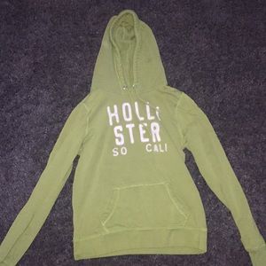 Green hoodie with sewn on letters